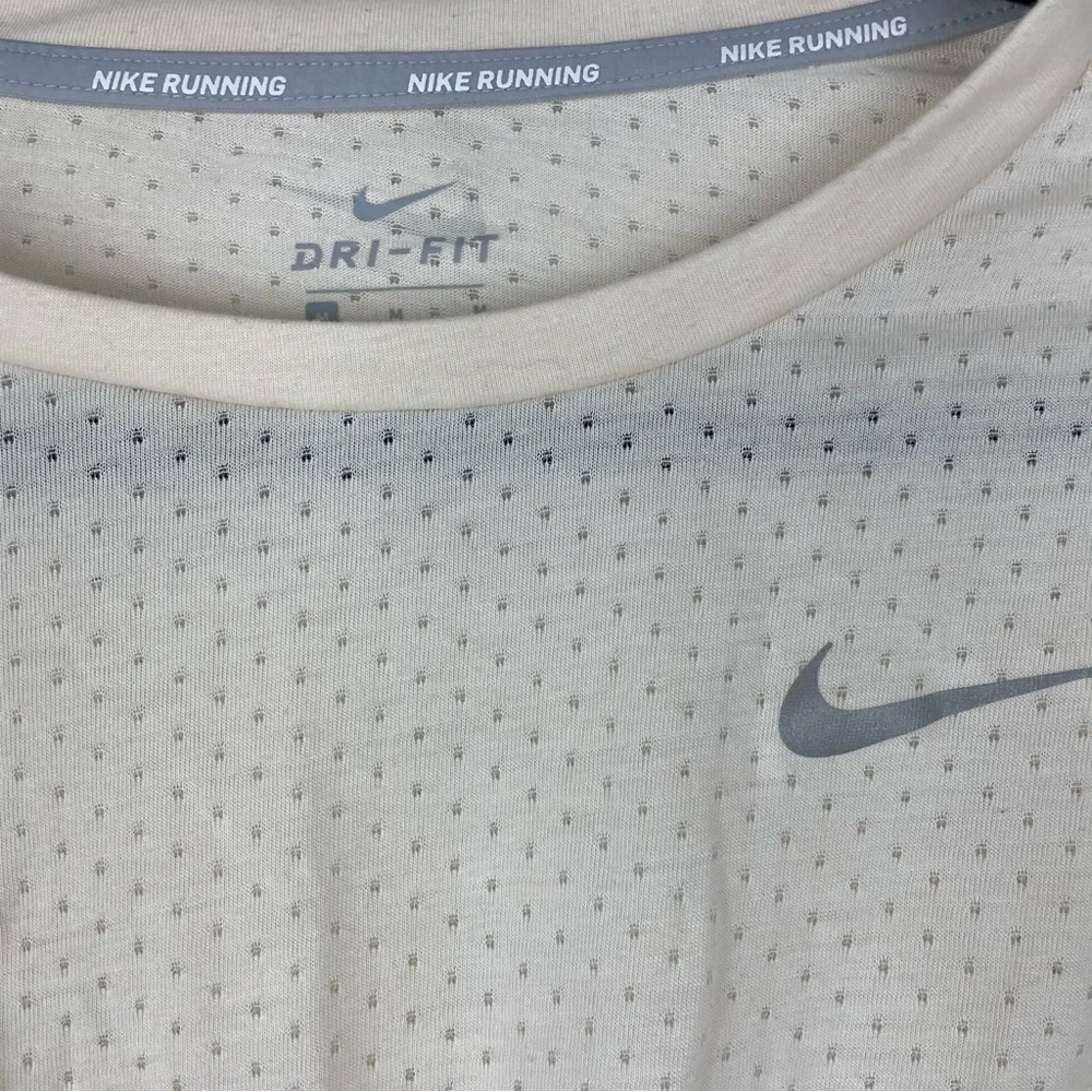 Nike cream medium perforated running crop top